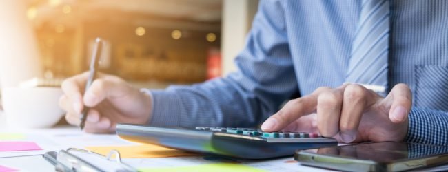Business finance man calculating budget numbers, Invoices and financial adviser working.